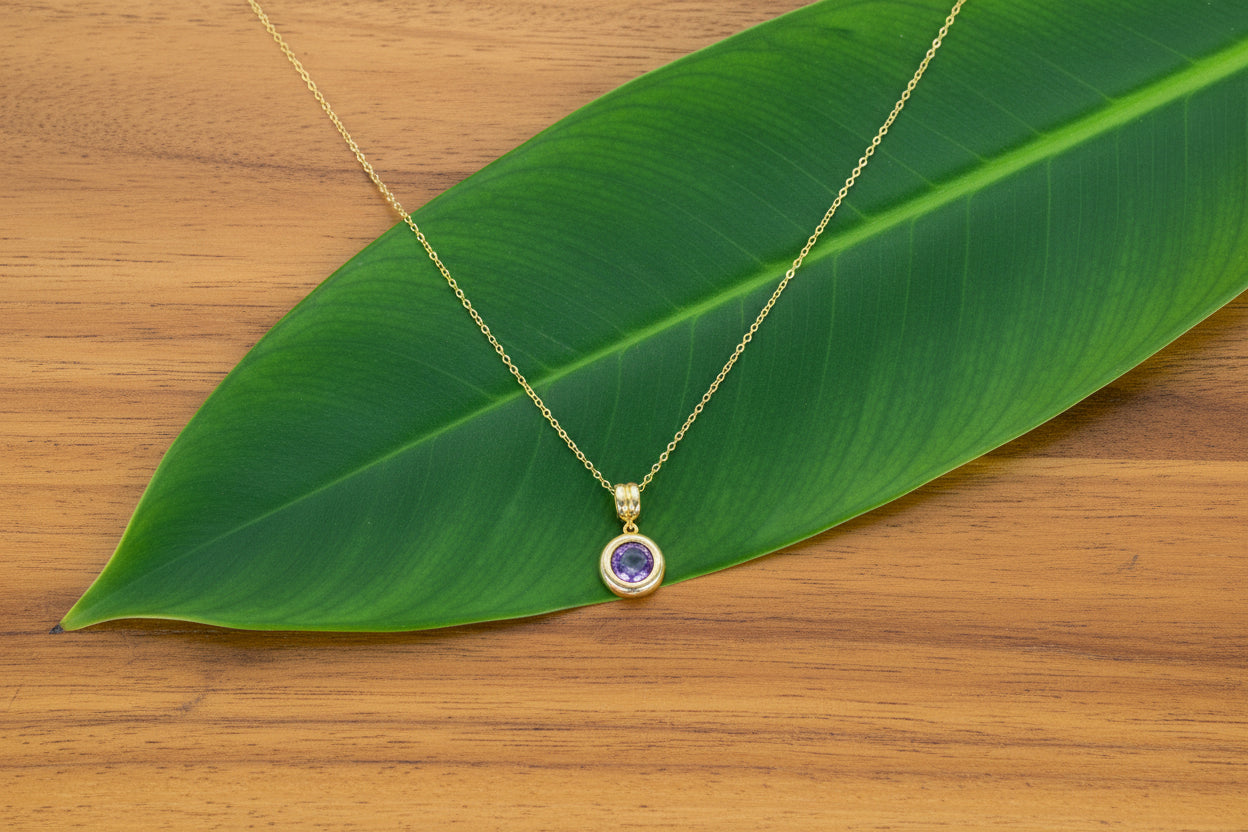 Amethyst solitaire pendant necklace made from 18K gold-plated stainless steel.