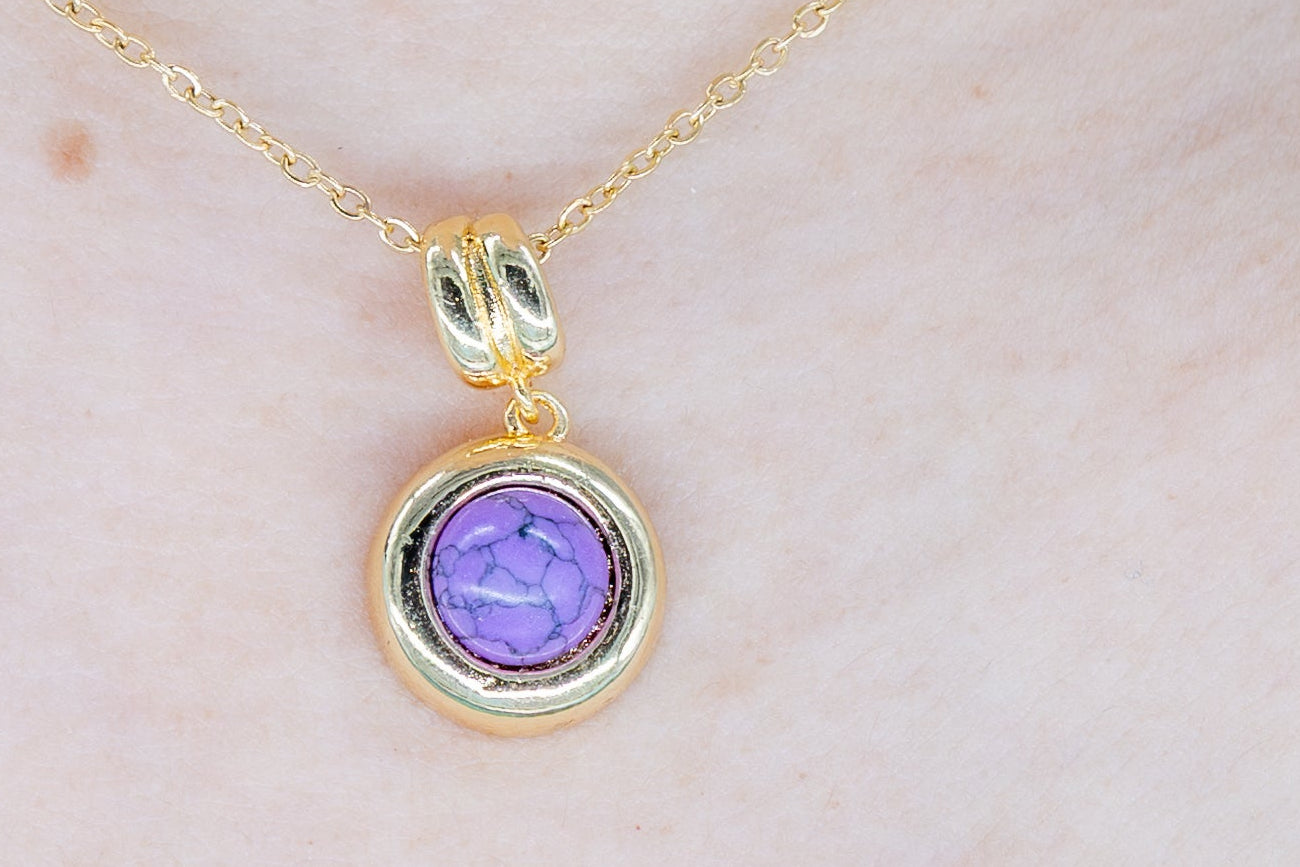 Amethyst solitaire pendant necklace made from 18K gold-plated stainless steel.